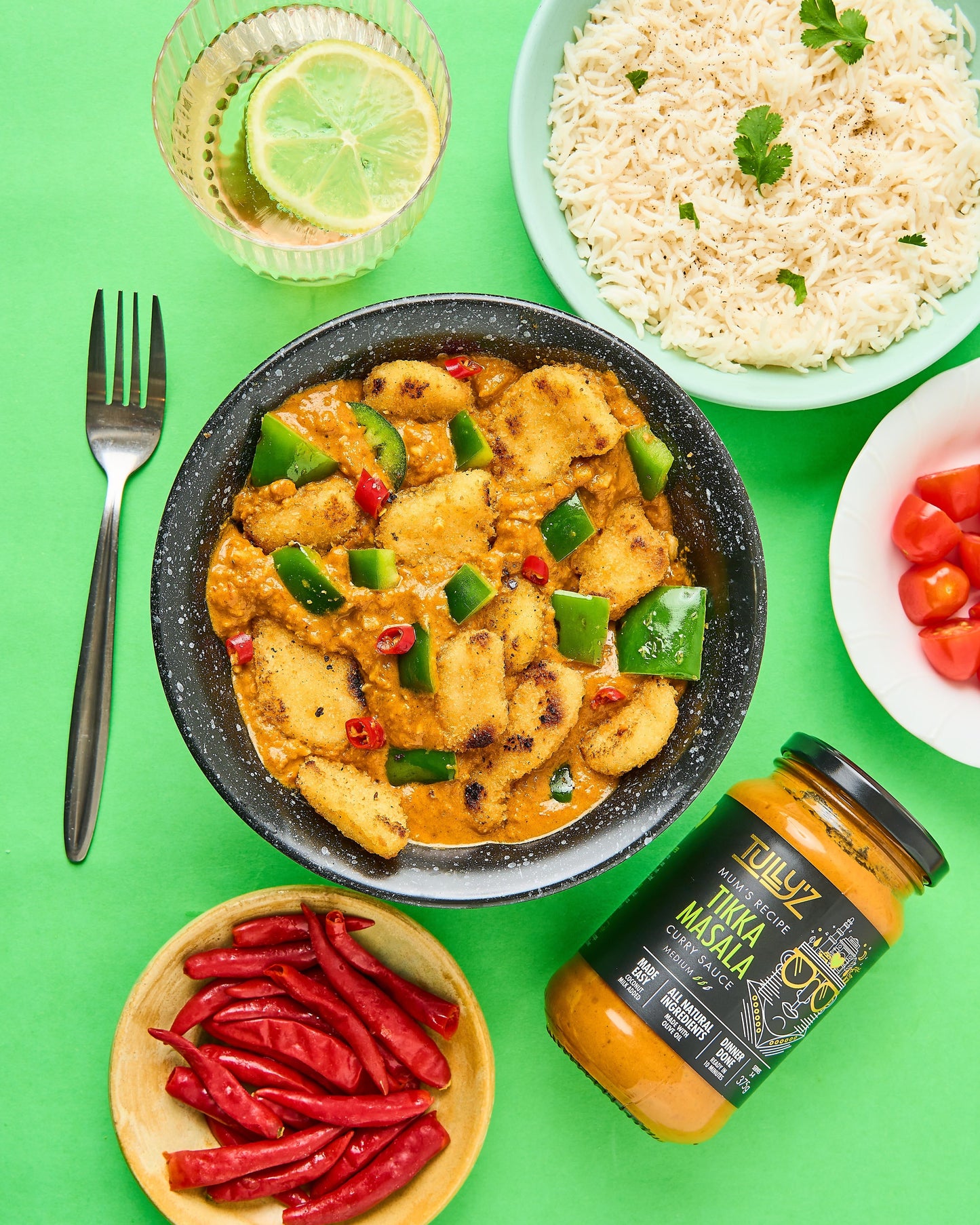 Tikka Masala Chicken Nugget Curry with green capsicum and fresh chili garnish.