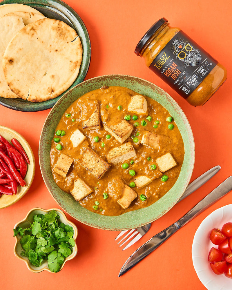 Rogan Josh Tofu and Pea Curry garnished with fresh coriander, served with rice.