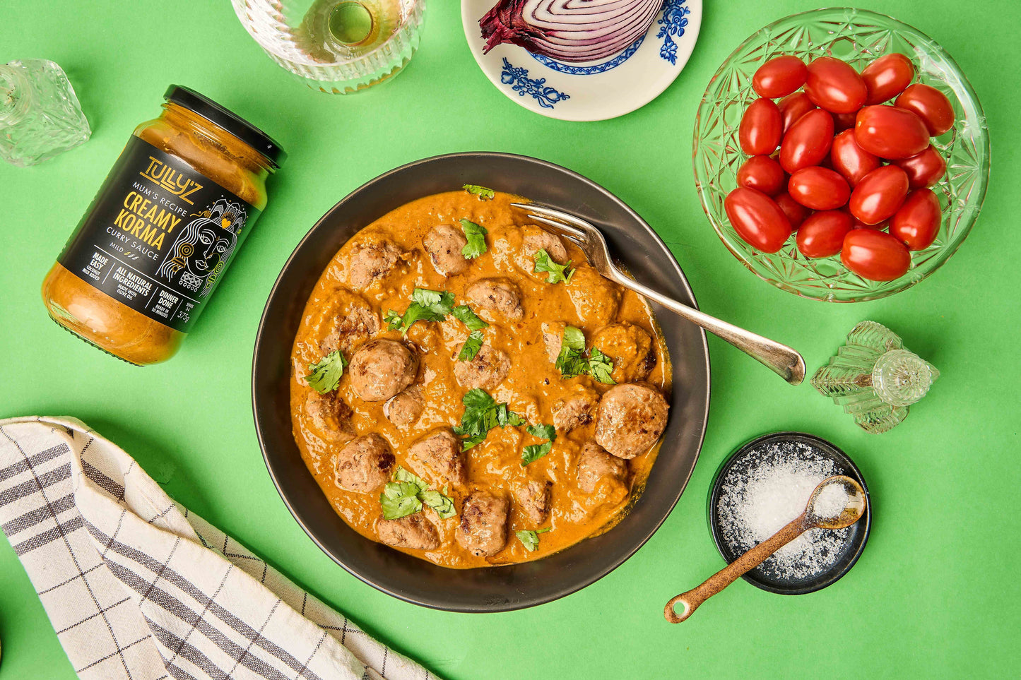 Creamy Korma Chicken Meatball Curry served with rice and garnished with fresh coriander.