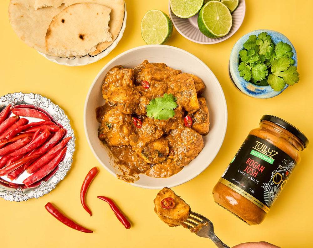 A bowl of Rogan Josh Potato Curry garnished with fresh coriander.