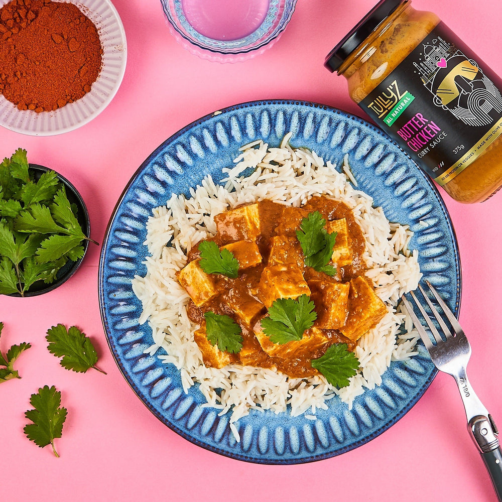 Butter chicken curry served with tofu, fresh coriander, and basmati rice.