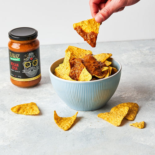 Rogan Josh Curry Sauce poured over crispy corn chips, garnished with fresh coriander